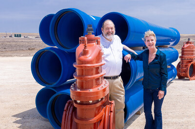 (left to right) SE Legacy Development LLC General Counsel & Chief Development Officer, David E. Earl, joins SE Legacy Development LLC President, Kandy Walker, next to massive undergrounding piping and large water flow regulators to be used on the over 40 water wells being drilled on the $7+ Billion development's property (note new green water wells in the distant left of the picture)