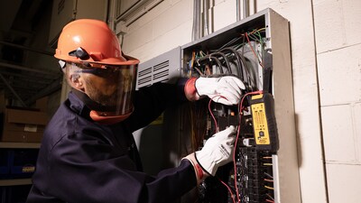 Electrician Greg Anliker using the IDEAL SureTrace™ Circuit Tracer PLUS (61-948) to test for continuity on an open panel.