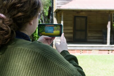 A visitor uses her cell phone to see AR-enhanced information while touring Georgia College & State University's Andalusia property in Milledgeville, Georgia.