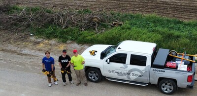 Everlight Solar's Hudson McCoy, Nic Seamann, and Matthew Myers (left to right) clean up wreckage along the highway