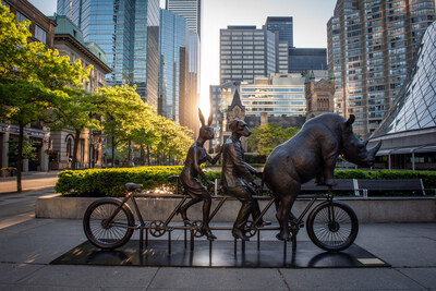 Today in the early hours of the morning, a new bronze sculpture pedalled into David Pecaut Square in Toronto's Entertainment District. He Was On A Ride to a Safer Place, by world-renowned artists Gillie and Marc, invites passersby to hop on the fourth seat and take a whimsical ride while delivering messages of equality, acceptance, and conservation. The sculpture will be on display for one year and was brought to the city by the Toronto Downtown West BIA. (CNW Group/Toronto Downtown West BIA)