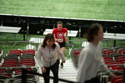 3x Team Canada Olympic athlete Jason Burnett running up the stands of BC Place stadium. Burnett completed the double bowl challenge, climbing twice around the lower bowl. (CNW Group/World Wildlife Fund Canada)