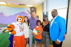Extending a paw: Coach Dabo Swinney helps deliver My Special Aflac Duck® to children ahead of the Aflac Kickoff Game