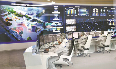 Staff members of the Yili Group, a major dairy producer, monitor production of a dairy factory in real-time at a digital center in Hohhot, Inner Mongolia, in 2022. [Photo provided to China Daily]