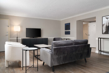 An open suite-styled room with modern furnishings.