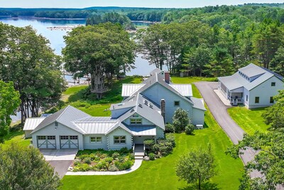 The property's three living structures include a 2-story main residence (center), oversized studio (right) and a charming guest cottage (upper middle; partially visible). The +10.5-acre parcel sits on the Bagaduce River in the town of Penobscot, just 45 mins south of Maine's Bangor Airport. MaineLuxuryAuction.com.