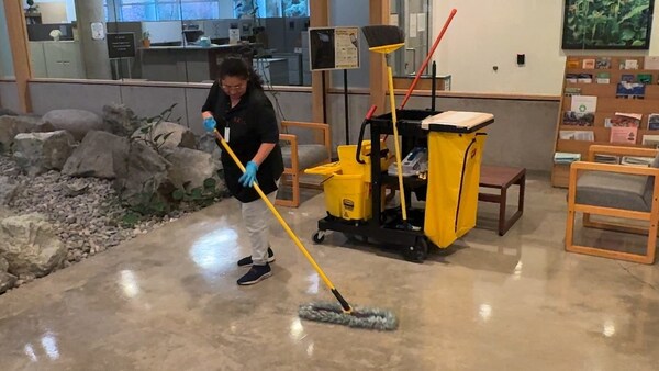 A SealX team member performs cleaning services at the Washington State Department of Ecology headquarters in Olympia, WA.