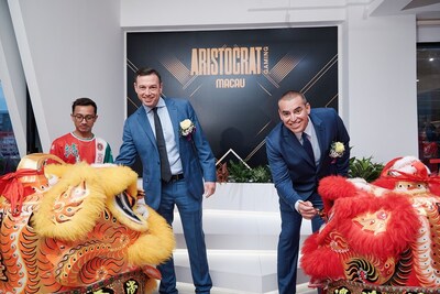 Aristocrat Gaming General Manager of APAC Lloyd Robson, left, and Aristocrat Gaming CEO Hector Fernandez, right, celebrate the grand re-opening of the newly renovated Aristocrat Gaming Macau office.