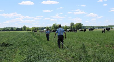 Family farmer-owners in Iowa set up a new fence for their cows.