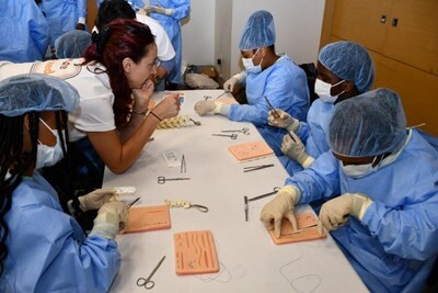 Students scrub in to practice surgical suturing skills