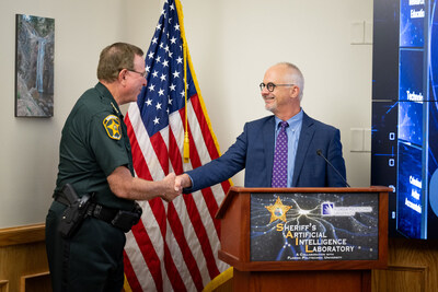 Dr. Randy Avent, Florida Polytechnic University's president, greets Sheriff Grady Judd at the announcement of a new Artificial Intelligence investigative unit in partnership with the Polk County Sherriff's Office on June 7.