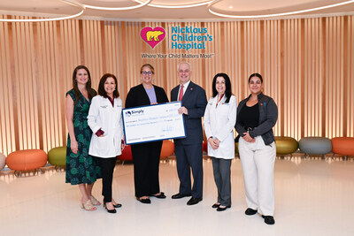 Simply Healthcare Plans team presents a $175,000 check to Nicklaus Children's Hospital to support the one-on-one psychology sessions conducted by licensed psychologist Silvia Sommers to support families who have a child recently admitted to the neonatal intensive care unit or cardiac intensive care unit.