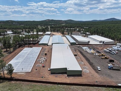 The left concrete pad and middle building show the progress of the 74 fully enclosed RV and boat units opening July 2024.