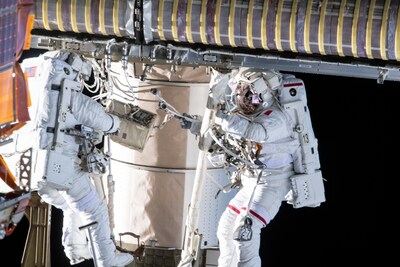 Astronauts pictured completing an installation outside of the International Space Station. Credits: NASA