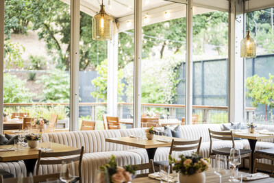 The sunlit, serenely appointed dining room at Meadowood Napa Valley’s Forum restaurant, nestled in the forested hillsides of St. Helena, California.