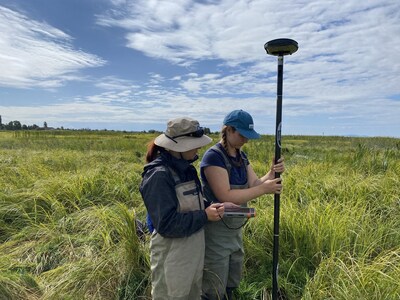 Two field staff take measurements as part of ongoing effectiveness monitoring to help understand baseline and ongoing data that informs the success and areas for improvement of individual conservation efforts. [Credit: Ducks Unlimited Canada] (CNW Group/Ducks Unlimited Canada)