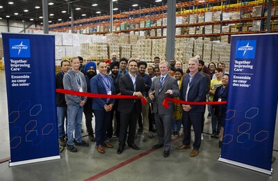 Medline Canada officially opened its new 160,000-square-foot western distribution hub today in Rocky View, Alberta, just north of Calgary. Pictured with Medline distribution centre employees Medline’s Chief Operating Officer, Kaveh Razzaghi, left, and Alberta’s Parliamentary Secretary for Rural Health and MLA, Martin Long, right, cut the ribbon to mark the occasion. (CNW Group/Medline Canada, Corporation)