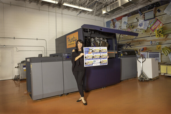 PostcardMania Founder/CEO Joy Gendusa with PostcardMania's first of four digital Konica Minolta printing presses. PostcardMania installed its fourth and latest Konica Minolta press in April 2024 to expand the printing capabilities of its fastest-growing direct mail automation division, PCM Integrations.