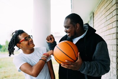 Joshua, a 14-year-old student and athlete from Louisiana, with his dad, Josh. Joshua's life changed when he was introduced to Sight For Kids. Joshua dreams of becoming an engineer when he grows up and has a love for basketball, which has grown even deeper now that he can see the basketball hoop clearly. Photo credit: Kate T. Parker