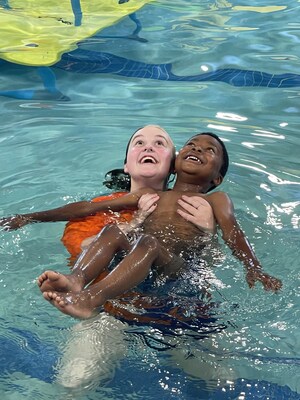 World's Largest Swimming Lesson (WLSL) participant Brian Moore practices floating on his back with swim instructor Lacey Cooper at the Goldfish Swim School in Overland Park, Kansas. The swim school was one of hundreds of participating WLSL event locations on six continents. The global event raises awareness about the importance of water safety and helps teach families the critical swimming skills needed to be safer in and around the water.
