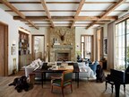 In the great room of Stags Landing, two opposing stacked stone fireplaces underscore classical symmetry, while two beautiful office dogs greet guests and clients (PC Roger Davies).