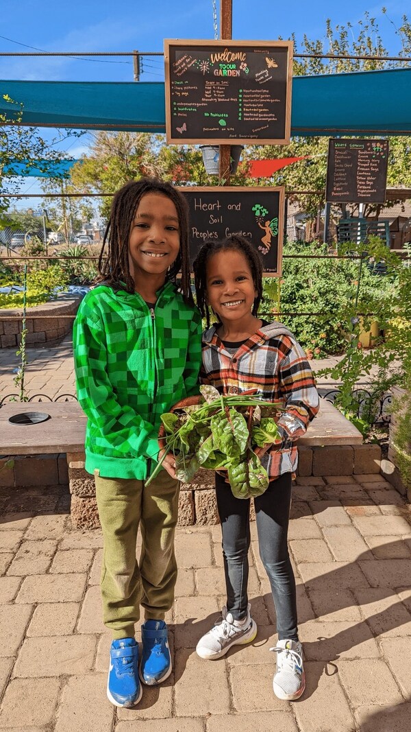 Two smiling children at the Heart & Soil People's Garden, which provides health food to more than 50 central Phoenix families