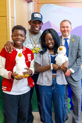 Deion “Coach Prime” Sanders and Aflac Chief Marketing Officer Garth Knudson provide My Special Aflac Ducks to Elly and Abigail, who are being treated for sickle cell disease, during a special event held at Children’s Hospital Colorado on Monday
