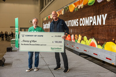 SpartanNash CEO Tony Sarsam presents a check to the Company's nonprofit partner, Convoy of Hope, at Helping Hands Day.