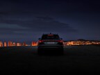 Audi Q6 e-tron with cityscape in background at night. Copyright: Audi AG.