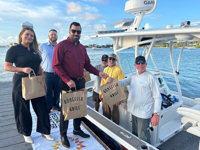 Bonefish Grill handing off a delicious dinner to Captain Red and his crew.
