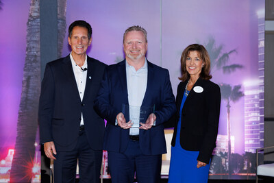 Greater Irvine Chamber's Dave Coffaro and Lisa Thomas present PSQ Productions' Mark Entner with the Celebrate Irvine Entrepreneur of the Year Award.