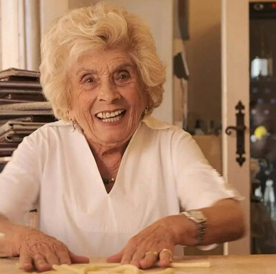 "Nonna Iris, 93 years old and affectionately known as the 'Carbonara Queen,' brings a century-old tradition of pasta making to Miami with her restaurant, Osteria da Fortunata. Born and raised in Rome, Iris started in the family kitchen at 13 and now runs multiple successful restaurants across Italy. Her Miami establishment is named after her grandmother, continuing the legacy of serving authentic Roman delicacies. Iris's secret to success is simple: kindness and giving people good food"