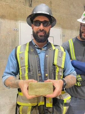 Figure 2 – Vincent-Luc Authier, Construction Manager at TZ with the First Gold Bar Poured at the Mine (CNW Group/G Mining Ventures Corp)