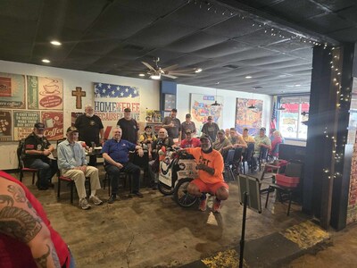 Robert Luna, a retired Coast Guard veteran and chief petty officer, is walking from Alabama to California to raise awareness for mental health issues in the military and support for the Coast Guard Foundation’s programs. He is pictured here with a group of veterans from the local VFW in Searcy, Arkansas.