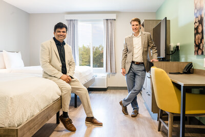 Hotel owner Philip Cox, right, and Wyndham’s Krishna Paliwal, left, show off a double queen suite at the newly opened ECHO Suites Spartanburg. Built for travelers seeking long-term stays, the hotel is the first of nearly 270 under development in the U.S. and Canada.