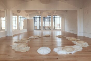 Open beautiful classroom with a circle of sheepskin rugs at The Canopy NYC