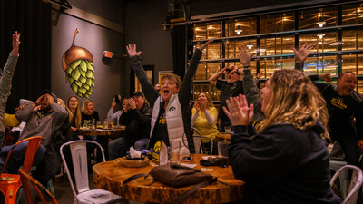Fans react during an Iowa game watch party at a Big Grove Brewery.