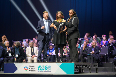 AMP announced as Category Winner at the 2024 World Choir Games. L to R: Günther Titsch, President, INTERKULTUR, World Choir Games, World Choir Council; Aisha Moody, Co-Founder & Chief Program Officer, Atlanta Music Project; B.E. Boykin, Conductor, Atlanta Music Project Senior Youth Choir. From July 13, 2024. Photo courtesy of World Choir Games.