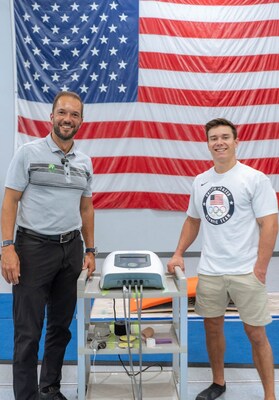 Garrett Salpeter and Olympic Gymnast Brody Malone Stand Beside the Neubie Device, Showcasing the Power of Neuromuscular Innovation. Together, They Highlight the Revolutionary Impact of Neubie on Athletic Performance and Rehabilitation.
