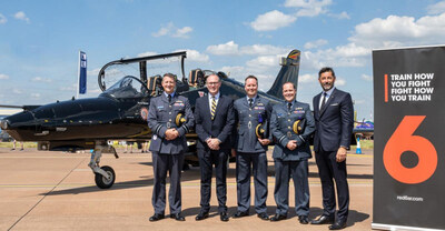 Representatives of BAE Systems and Red 6 pose with RAF officers in front of a Hawk T.Mk 2 during the Royal International Air Tattoo, which was held at RAF Fairford.
