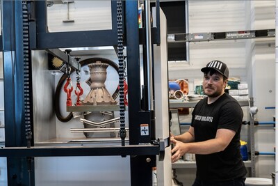 Ursa Major's Thomas Pomorski prepares one of its Hadley engine chambers for transport after 3-D printing is complete at its Youngstown OH manufacturing facility. Ursa Major announced today it has received a grant from JobsOhio to open a larger facility and hire 15 new people.