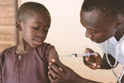 In this image, a black toddler is receiving his first antimalarial vaccine in a small rural African community dispensary