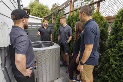 Contractor is explaining to the homeowners how a dual fuel system works through a connected thermostat that will switch between a heat pump and a high-efficiency gas furnace. (CNW Group/FortisBC)