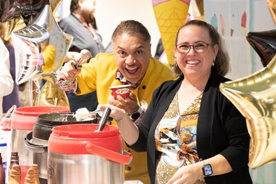 Raising a Cone – Synchrony's Osmar Blanco (left), Vice President and Hub Leader in Altamonte Springs, Fla. and Deborah Dillon (right) serve up ice cream during a local employee celebration to mark the company's decade as a force for good for its employees, customers, and communities. (Photo credit: Synchrony)