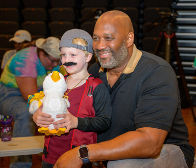 Emmett, a camper with Horizon Day Camp – Metro D.C., holds his My Special Aflac Duck® alongside Aflac SVP Federal Corporate Affairs and Public Policy Brad Knox. Aflac delivered more than 75 cuddly robotic companions to the camp Tuesday, July 30 along with a $70,000 donation.