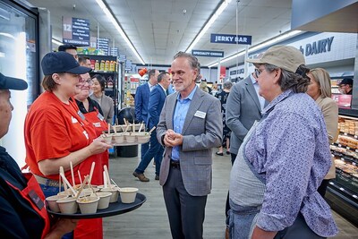 SpartanNash CEO Tony Sarsam samples some of the new fresh grab-and-go offerings now available at the Family Fare deli in Holland, Mich.