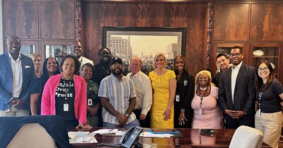 Something to Smile About: Mayor Duggan (center) joined by project stakeholders after approving the contract