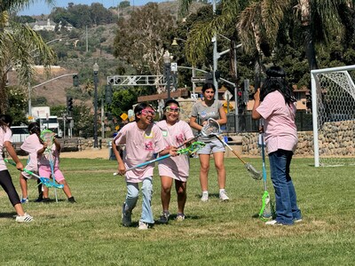 Girls learning lacrosse for the first time.