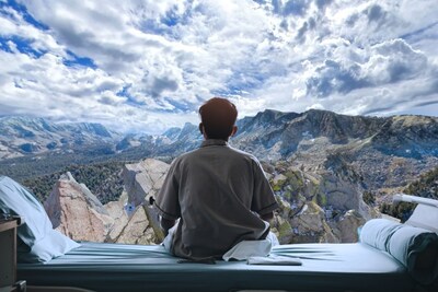 A patient in a hospital bed gazes at lifelike mountains, one of many immersive nature experiences offered on the Novobeing platform, made possible by the exclusive partnership with BRINK XR.