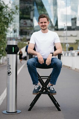 Simonas Stankus, CEO of Inbalance grid, with a company-made EV charging station